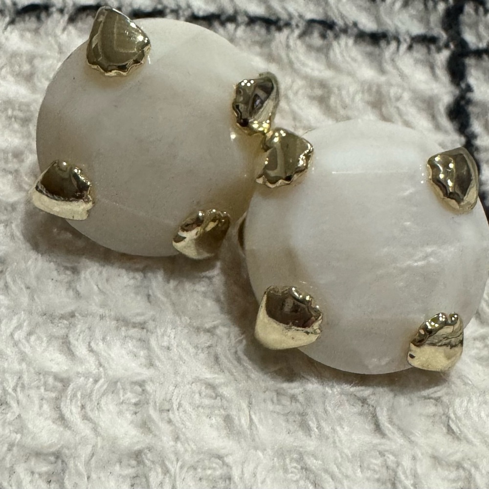 Kendra Scott White and Gold clip on earrings.
